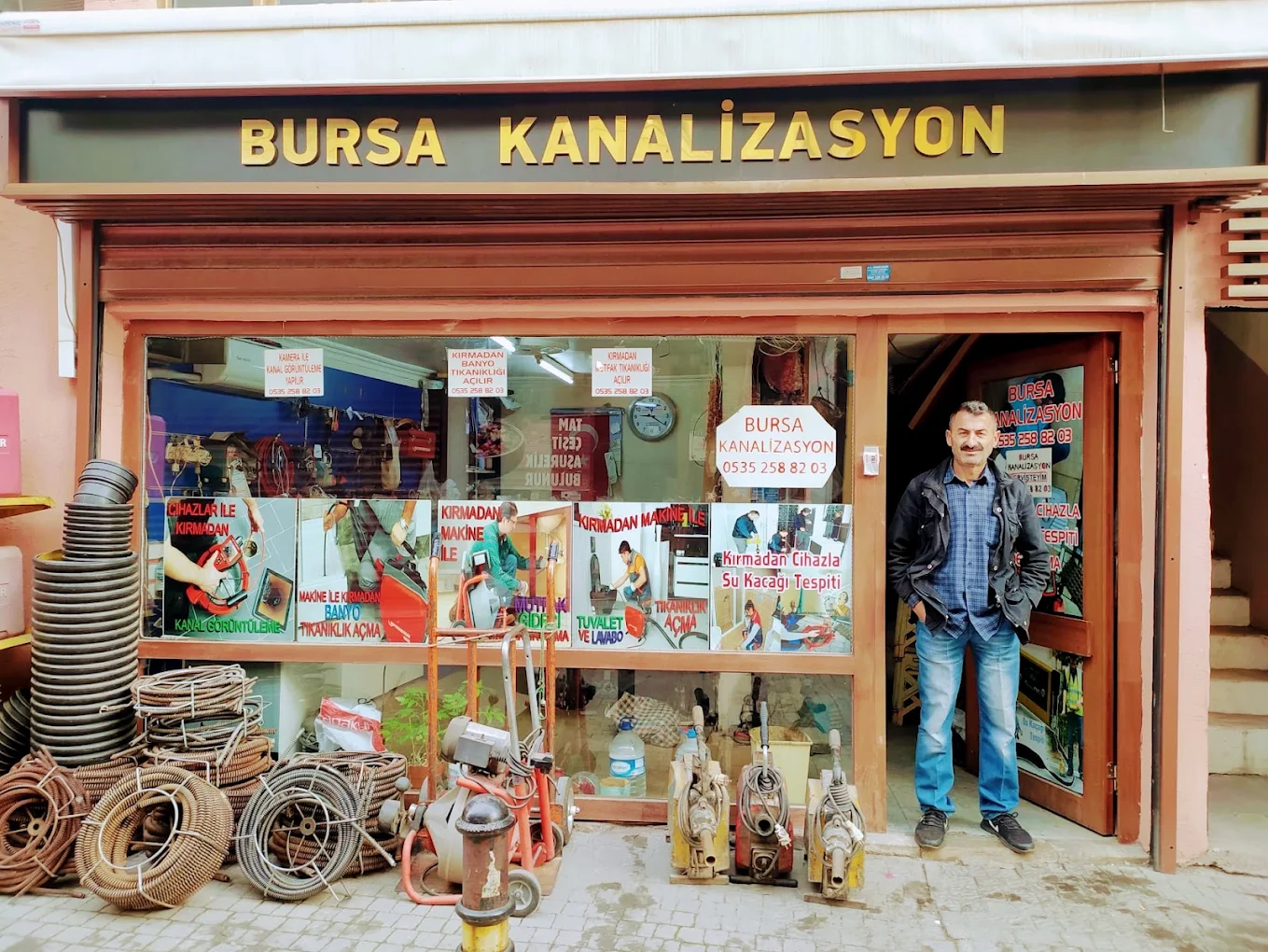 Erkan outside the Bursa Kanalizasyon shop with drain cleaning equipment